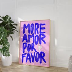 a pink poster with the words more amor por favor on it next to a potted plant