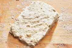 a piece of bread sitting on top of a wooden cutting board