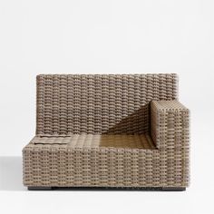 a wicker couch with an open seat