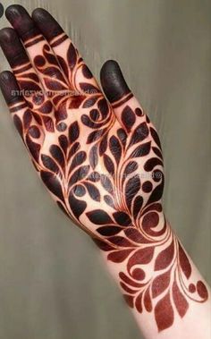 the hand is decorated with black and red designs on it's palm, which has an intricate design