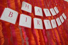 an orange and red birthday banner with the words happy birthday on it