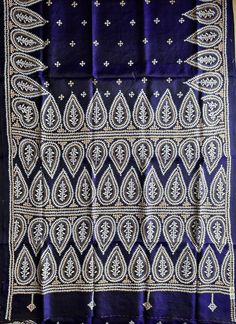 an embroidered blue cloth with white designs on it