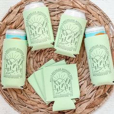 four green cups and napkins sitting on top of a wicker basket next to each other