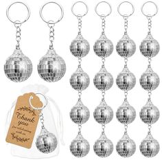 a bunch of silver disco ball key chains with a tag on it's side