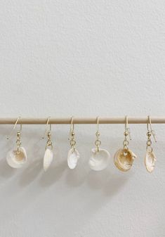 Cute and simple earrings for any occasion. Handmade seashell jewels. All shells were found in Seaside Park, NJ. Jewels are nickel free.  All shells are real. Color and size may vary for each shell, as each one is natural and unique.  -  - For the past few years, I have been collecting these small seashells hoping to do some type of project with them. I found that many of the shells I kept had small, perfectly round holes poked in them. After doing some researching this, I discovered something fa Minimalist Beach Jewelry With Ear Wire, Minimalist Handmade Earrings For Beach, Nickel-free Shell Dangle Earrings, Nickel-free Ocean-inspired Shell-shaped Shell, Ocean-inspired Nickel-free Shell-shaped Shell, Nickel-free Ocean-inspired Shell, Nickel Free Ocean-inspired Shell Jewelry, Nickel-free Ocean-inspired Shell Jewelry, Nickel-free White Shell