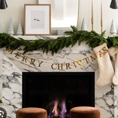 a fireplace decorated for christmas with stockings hanging over it