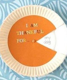 an orange and white paper plate with the words i am grateful for my dog on it