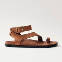 a woman's tan sandals with two straps