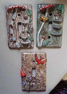 three decorative switch plates on the wall with mushrooms and toades painted on them,