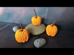 three small pumpkins sitting on top of some rocks and stones with the word slow written in