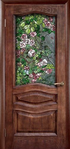 a wooden door with stained glass and flowers on it