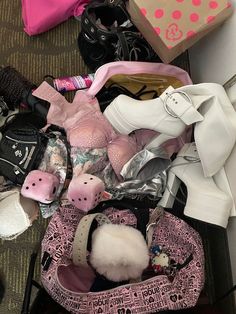 a pile of shoes and other items sitting on the floor