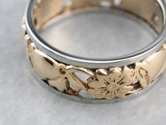 This band is very subtle, a combination of cut-outs and floral motifs. This vintage band dates to the mid-1900s and is well suited to a man or a woman. It's wider than many modern bands and engraved with a scrolling flower pattern. The quality of manufacture is very nice, and this will be a great piece for wearing alone or with an engagement ring. Metal: 14K Rose Gold, 18K White Gold Width of Band: 6.6 mm Height off Finger: 1.6 mm Ring Size: 5.50 Marks: "14-18K" Stamped on the inside band Flower Wedding Band, Floral Filigree, Flower Band, Stacking Bands, Cameo Ring, Right Hand Rings, Ring Metal, Vintage Band, Anniversary Bands