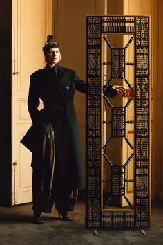 a woman standing next to a tall display case