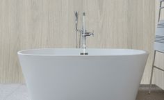 a white bath tub sitting on top of a tiled floor