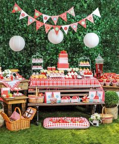 a pink and white dessert table with lots of food