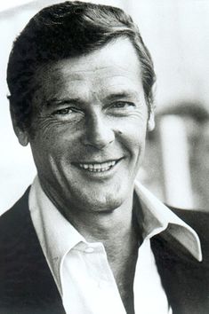 a black and white photo of a man smiling