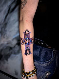 a person with a cross tattoo on their arm