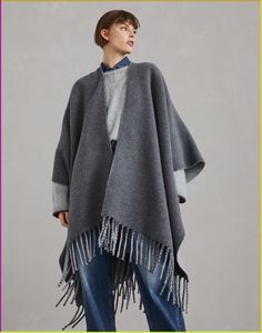 Wool and cashmere reversible double knit poncho This double knit poncho conveys the perfect balance between cozy comfort and timeless style. The refined double knit is crafted with two layers of fabric bonded together to create a garment with a compact texture that is extraordinarily soft to wear. The unconstructed wide, fluid silhouette drapes over the body and will follow every move with an elegant naturalness. Tuxedo T Shirt, Knit Poncho, Cashmere Fabric, City Outfits, Knitted Poncho, Eyewear Womens, Double Knit, Boutique Online