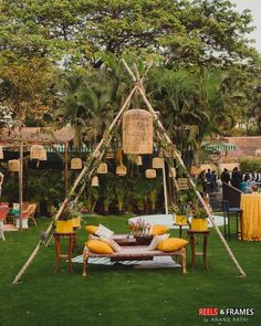 an outdoor seating area is decorated with yellow cushions and wicker furniture, as well as palm trees