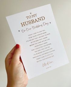 a person holding up a card that says, to my husband on our wedding day