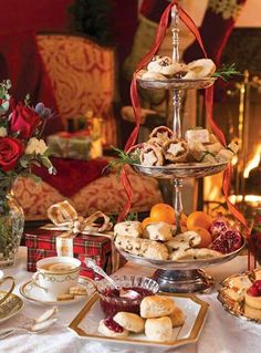 three tiered trays filled with pastries and fruit on top of a table