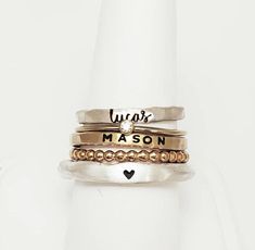 Personalized stackable ring set, engraved with names, a date, or a special word.  Metal: .999 fine silver, 14k gold filled Font: lowercase new cursive, uppercase bold block, and lowercase typewriter (if you want a word instead of a heart on the silver ring) Handmade in Brownsburg, Indiana. Please read our policies before purchase. Connect with us on social media @ShopGoingGolden Everyday White Gold Rings With Engraving Option, Silver Custom Name Jewelry For Everyday, Customizable Adjustable Stackable Rings For Everyday, Custom Name Silver Jewelry For Everyday, Everyday Adjustable Stackable Engraved Ring, Adjustable Stackable Initial Ring, Adjustable Engraved Stackable Ring For Everyday, Personalized Adjustable Rings For Everyday, Personalized Adjustable Ring Jewelry