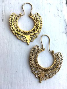 handcast in India, intricate style brass earrings statement piece that spices up any plain outfit at work, or out on the town Intricate Brass Hoop Earrings, Festive Brass Chandelier Earrings For Pierced Ears, Festive Brass Hoop Earrings With Intricate Design, Metal Chandbali Earrings With Filigree, Antique Gold Earrings With Intricate Design For Festive Occasions, Ornate Bronze Earrings, Festive Gold Brass Plug Earrings, Filigree Chandbali Earrings, Gold Earrings With Oxidized Finish For Festive Occasion