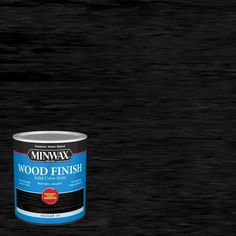 a can of wood finish sitting on top of a black flooring material that looks like it has been painted