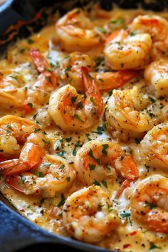 a skillet filled with shrimp and cheese