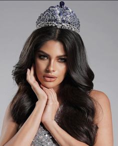 a woman wearing a tiara and posing for the camera