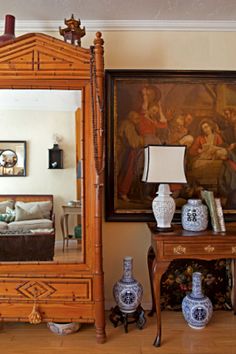 a living room filled with furniture and a large mirror