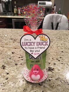 a pink rubber duck sitting in a bag on top of a counter