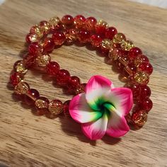 Handmade Stretch Bracelet. Hawaiian Flower With Double Beaded Bracelet Attached. Can Fit Wrists From 5 To 8 Inches Round Nicely. Save More $$$ On Bundles!!! Buy 3 Or More Items And Receive 30% Off!!! I Ship On The Same Day Unless You Make A Purchase At Night Then I Ship First Thing The The Morning. I Am A Quick Responder And If You Have Any Questions About An Item I Will Quickly Give You An Answer Or Post A Video Of The Item In Question. I Try To List All My Items At A Reasonable Price But I Als Flower Shaped Stretch Bracelet For Gift, Flower Shaped Stretch Bracelet As Gift, Flower-shaped Stretch Bracelet As Gift, Adjustable Flower Beaded Bracelet With 8mm Beads, Adjustable Red Flower Beaded Bracelet, Red Flower-shaped Beads For Gifts, Red Bohemian Flower Beaded Bracelets, Red Flower-shaped Bohemian Beaded Bracelets, Bohemian Red Jewelry With Flower Decoration