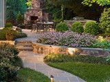 an outdoor patio with stone steps and landscaping