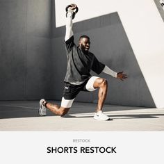 a man in black shirt and white shorts playing with a tennis racquet on concrete