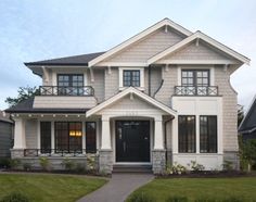 a large house with lots of windows on the front and side of it's roof