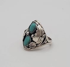 Fancy turquoise sterling silver statement ring.  This amazing ring is crafted in the dome style and is a multi-stone ring featuring stunning detail in the silver work.  This ring has gorgeous 925 sterling silver leaf design and two beautiful cabs of turquoise as its crowning jewel.  This statement piece would make a great gift for dad for a birthday, Valentines Day gift, anniversary or a great graduation or birthday gift!    I only have  few of these rings left, so PLEASE check with me on sizing before ordering!  Also, please check out my other listings in my Etsy shop to find necklaces, bracelets and earrings to compliment this piece. Elegant Handmade Silver Dome Ring, Nickel Free Ring For Anniversary, Fine Jewelry Nickel-free Ring, Heirloom Sterling Silver Cabochon Jewelry, Nickel-free Ring For Anniversary, Heirloom Sterling Silver Open Ring, Unique Engraved Turquoise Jewelry, Nickel-free Fine Jewelry Ring, Nickel-free Anniversary Ring