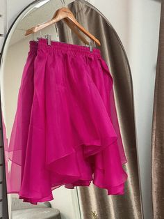 A flowing flared silk skirt cut out of layers of organza, the Freesia Skirt is an image of grace and romance. Wear with your favorite tee or the matching Lin Organza Tee. Elastic silk waistband, delicately lined with silk habotai for coverage. Available in fuchsia. 100% silk organza, silk habotai. Made in New York's Garment District by a small team of dedicated seamstresses. Ships in 10 business days. Pink Silk Evening Skirt, Flowy Party Skirt With Ruffles, Pink Silk Pleated Skirt, Silk Draped Skirt With Lined Detail For Party, Pink Silk Full Skirt, Summer Party Draped Tiered Skirt, Pink Silk Skirt For Cocktail, Pink Silk Cocktail Skirt, Flowy Pleated Party Skirt