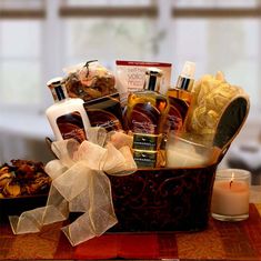 a brown basket filled with lots of different types of skin care products next to a candle