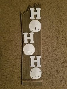 a wooden sign that says ho ho ho with clocks cut out of it's sides