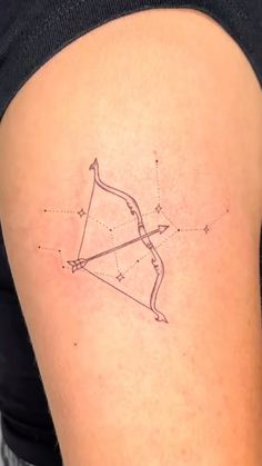 a woman's arm with a tattoo on it that has a bow and arrow