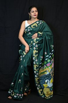 This authentic patachitra silk saree has an artistic depiction of motifs that illustrates a story. The painting on the saree is the handwork of the artists that the district of Puri is famous for. These are storytelling fabrics. This is a genuine handwoven piece, unevenness in the selvedge and weave could be expected, and colors may fade or bleed due to the traditional dyeing method employed. Specification: Occasion: Festive Wear Fabric: Pure Silk Primary Color: Green Secondary Color: Green Material :  Pure Silk Pattern: Motif Border Type: Handicrafts Border Size: Medium Blouse Piece: Included Care: Dry Clean Disclaimer : This is a genuine handwoven piece, & that could expect unevenness in the selvedge and weave, and colours may fade or bleed due to the traditional dyeing method employed. Patachitra Paintings Saree, Artistic Tussar Silk Saree With Motifs, Artistic Katan Silk Saree With Traditional Drape, Artistic Katan Silk Saree In Traditional Drape, Green Embroidered Paithani Silk Traditional Wear, Traditional Green Unstitched Digital Prints, Artistic Saree With Motifs For Navratri, Artistic Handloom Saree, Artistic Handloom Traditional Wear For Diwali