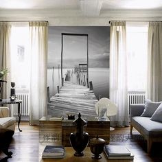 a living room filled with furniture and a painting on the wall