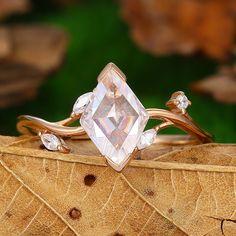 a close up of a ring on top of a leaf