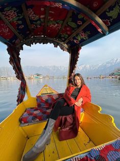 a woman is sitting on the back of a boat