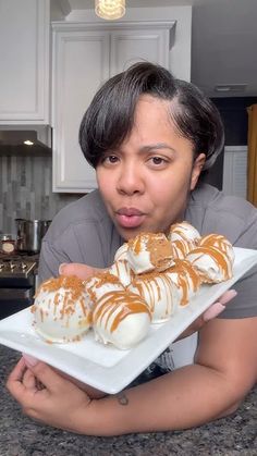 a person holding a plate with food on it in front of them and making a funny face