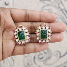 These earrings are perfect for adding a touch of glamour to both traditional Indian attire and contemporary outfits. Ruby kundan with their deep red hue, add a pop of vibrant color and symbolize passion and vitality. The carved emerald is the centre if attraction for the earrings. Material : 925 Hallmarked Silver Stones : Semi-precious polki , emerald, Ruby kundans and CZ's