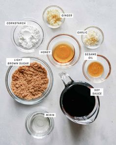 the ingredients to make an apple cider recipe are shown in small bowls on a white surface