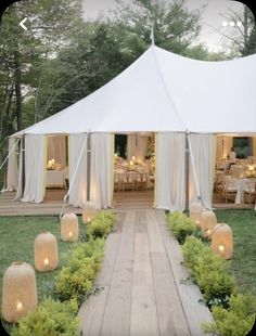 a large white tent set up with candles